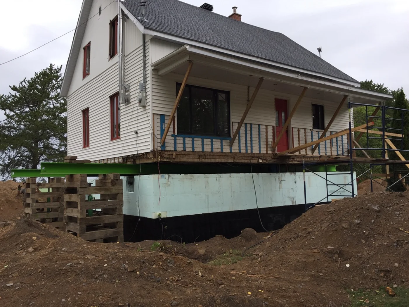 House lifted on cribbing for a complete foundation rebuild